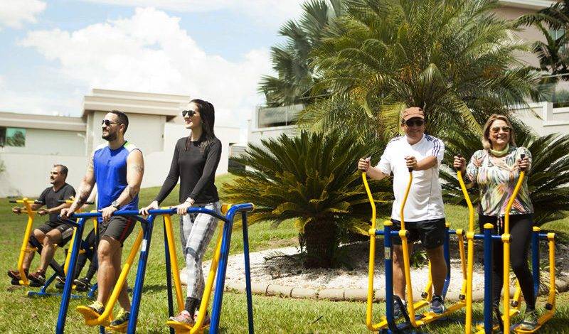 People exercising on outdoor fitness equipment at a park